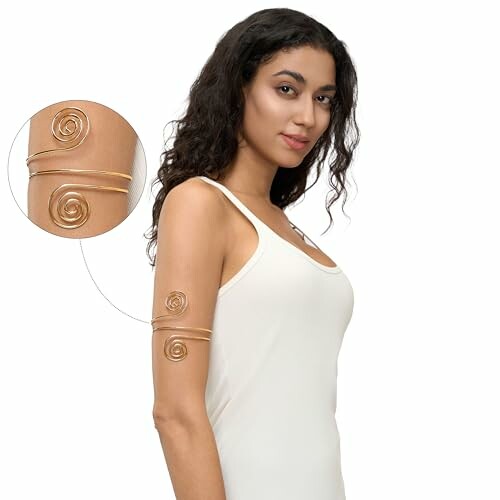 Woman wearing a gold spiral arm cuff bracelet on upper arm.